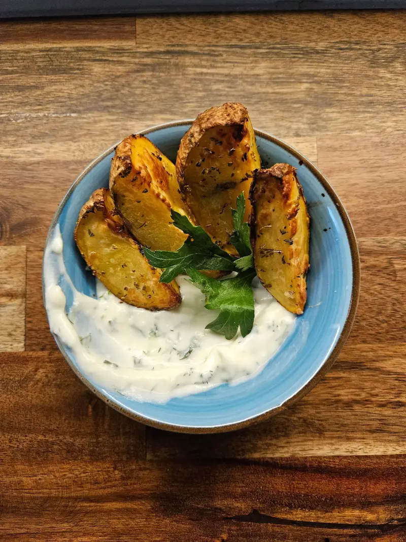 Patates Lemonates mit Tzatziki in einer blauen Schale